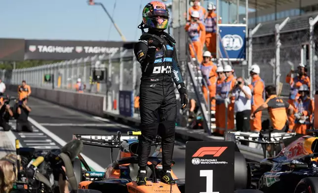 McLaren driver Lando Norris of Britain celebrates his pole position after the qualifying session for the Spanish Formula One Grand Prix in Madrid, Saturday, Sept. 12, 2026. (AP Photo/Bernat Armangue)