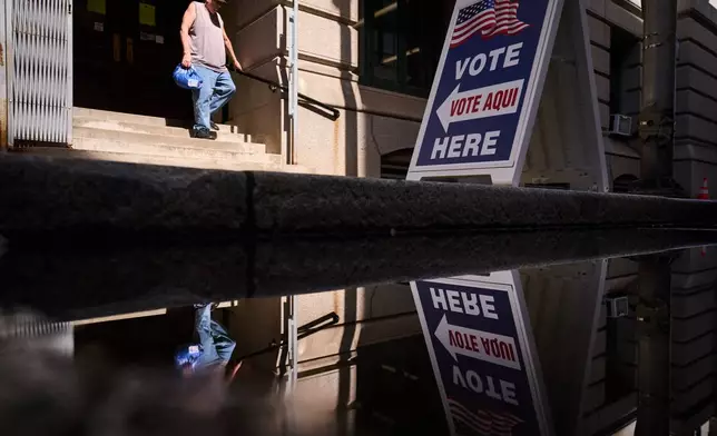 A sign directs voters to an entrance for City Hall during early voting for the Rhode Island primary election, Wednesday, Sept. 2, 2026, in Providence, R.I. (AP Photo/David Goldman)
