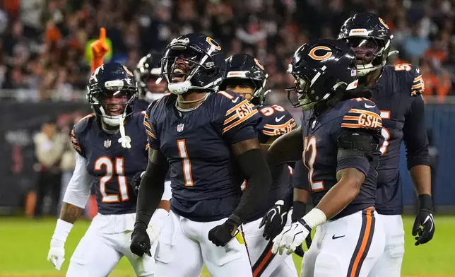 Chicago Bears defensive back Jaylon Johnson (1), Cam Lewis (21), Devin Bush, right, and others celebrate a defensive stop during the second half of an NFL football game against the Philadelphia Eagles in Chicago, Monday, Sept. 28, 2026. (AP Photo/David Banks)