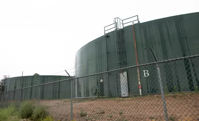 Reserve water tanks for holding drinking water for Grand Canyon Village stand behind fencing, Monday, Aug. 31, 2026, in Grand Canyon National Park, Ariz. (AP Photo/Josh Biggs)