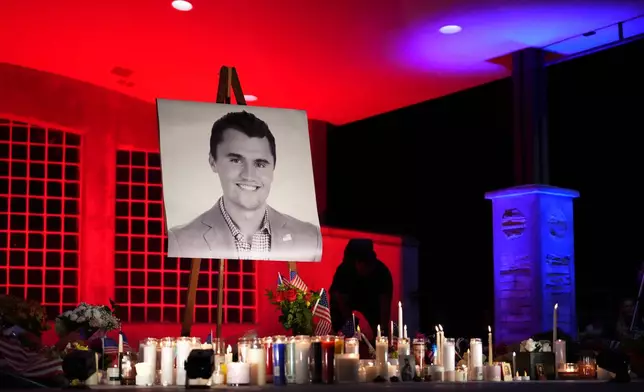 FILE - A photo of Charlie Kirk, the CEO and co-founder of Turning Point USA, stands at his vigil on Sept. 11, 2025, in Orem, Utah. (AP Photo/Lindsey Wasson, File)