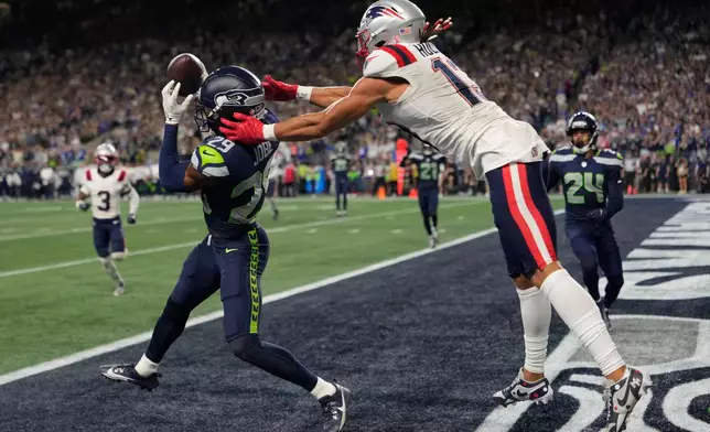 Seattle Seahawks cornerback Josh Jobe (29) intercepts a pass in the end zone intended for New England Patriots wide receiver Mack Hollins (13) during the second half of an NFL football game, Wednesday, Sept. 9, 2026, in Seattle. (AP Photo/Stephen Brashear)
