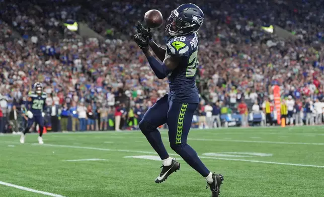 Seattle Seahawks cornerback Nehemiah Pritchett (28), intercepts a pass during the second half of an NFL football game against the New England Patriots, Wednesday, Sept. 9, 2026, in Seattle. (AP Photo/Lindsey Wasson)
