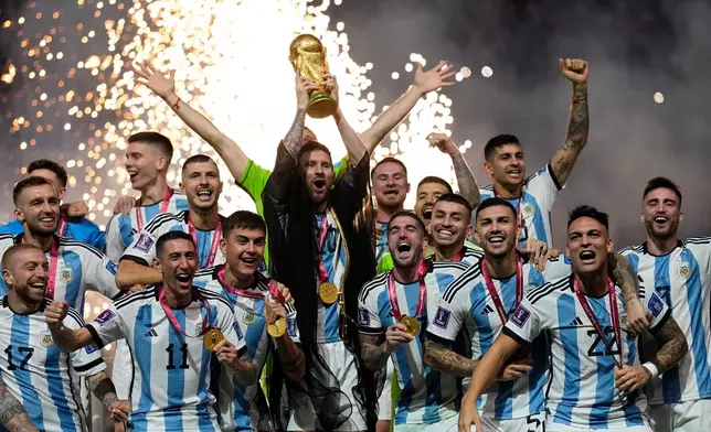 FILE - Argentina's Lionel Messi lifts the trophy after winning the World Cup final soccer match between Argentina and France in Lusail, Qatar, Dec. 18, 2022. Argentina won 4-2 in a penalty shootout after the match ended tied 3-3. (AP Photo/Martin Meissner, File)