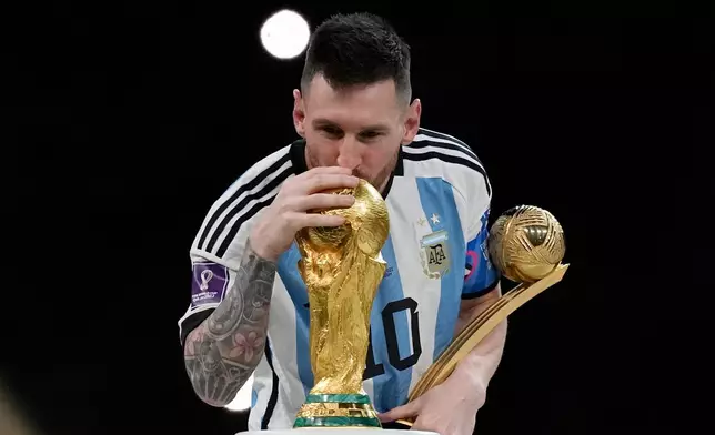 FILE - Argentina's Lionel Messi kisses the trophy after winning the World Cup final soccer match between Argentina and France in Lusail, Qatar, Dec. 18, 2022. Argentina won 4-2 in a penalty shootout after the match ended tied 3-3. (AP Photo/Martin Meissner, File)