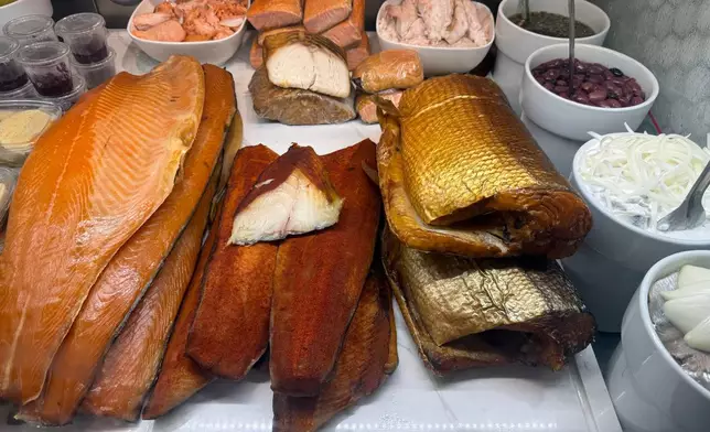 Various smoked fish are displayed behind the counter at Tal Bagels in New York on Sept. 13, 2026. (Katie Workman via AP)