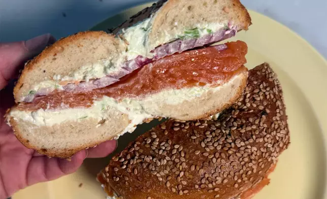 A bagel with smoked salmon, scallion cream cheese, and red onion, from Tal Bagels appears in New York on Sept. 13, 2026. (Katie Workman via AP)