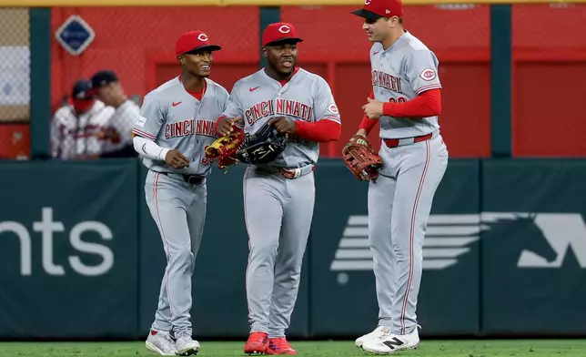Cincinnati Reds outfielders Carlos Jorge, left, Héctor Rodríguez, center, and JJ Bleday, right, celebrate after their team defeated the Atlanta Braves in a baseball game, Thursday, Sept. 24, 2026, in Atlanta. (AP Photo/Erik S. Lesser)