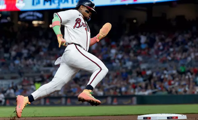 Atlanta Braves' Ronald Acuña Jr. runs from first base to score on a double by Michael Harris II, against the Cincinnati Reds during the first inning of a baseball game, Thursday, Sept. 24, 2026, in Atlanta. (AP Photo/Erik S. Lesser)