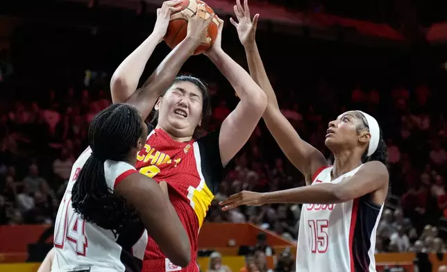 United States' Aliyah Boston, left, and Angel Reese guard China's Zhang Ziyu during the Women's Basketball World Cup match between China and the United States in Berlin, Friday, Sept. 4, 2026. (AP Photo/Ebrahim Noroozi)