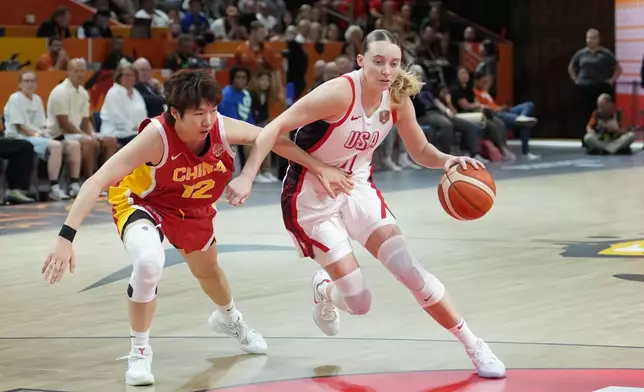 China's Chen Yujie guards United States' Paige Bueckers during the Women's Basketball World Cup match between China and the United States in Berlin, Friday, Sept. 4, 2026. (AP Photo/Ebrahim Noroozi)