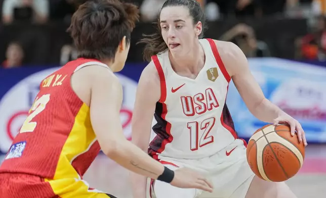 China's Li Yuan guards United States' Caitlin Clark during the Women's Basketball World Cup match between China and the United States in Berlin, Friday, Sept. 4, 2026. (AP Photo/Ebrahim Noroozi)