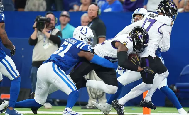 Baltimore Ravens' Derrick Henry gets past Indianapolis Colts' Akeem Davis-Gaither for a touchdown during the first half of an NFL football game Sunday, Sept. 13, 2026, in Indianapolis. (AP Photo/AJ Mast)