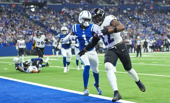 Baltimore Ravens' Derrick Henry runs for a touchdown past Indianapolis Colts' Sauce Gardner during the second half of an NFL football game Sunday, Sept. 13, 2026, in Indianapolis. (AP Photo/AJ Mast)