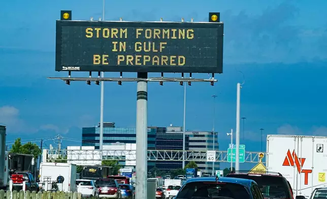 Motorists drive by Texas Department of Transportation signs on I-610 as Tropical Storm Edouard approaches in Houston, Tuesday, Sept. 1, 2026. (Elizabeth Conley/Houston Chronicle via AP)