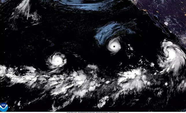 This satellite image released by NOAA shows three storms Hurricane Lowell, left, Hurricane Karina, center, and Tropical Storm Marie, right, forming in the Pacific Ocean, Wednesday, Sept. 2, 2026. (NOAA via AP)