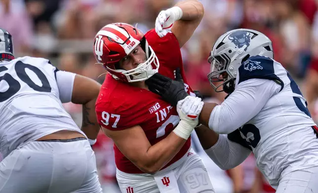 Indiana defensive lineman Mario Landino (97) battles Howard offensive lineman Guan Price II (55) during the second half an NCAA college football game, Saturday, Sept. 12, 2026, in Bloomington, Ind. (AP Photo/Doug McSchooler)