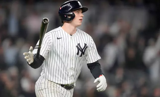 New York Yankees' Ben Rice watches his ball while hitting a grand slam off Boston Red Sox pitcher Brayan Bello during the eighth inning in Game 1 of baseball's American League Wild Card Series, Tuesday, Sept. 29, 2026, in New York. (AP Photo/Yuki Iwamura)