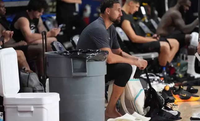 Miami Heat guard Klay Thompson sits on the sideline during the NBA basketball team's training camp, Tuesday, Sept. 29, 2026, in Boca Raton, Fla. (AP Photo/Lynne Sladky)
