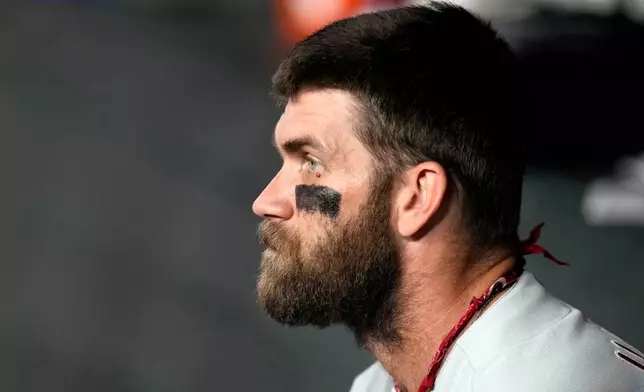 Philadelphia Phillies' Bryce Harper pauses in the team dugout during the third inning of a baseball game against the Arizona Diamondbacks, Wednesday, Sept. 2, 2026, in Phoenix. (AP Photo/Ross D. Franklin)