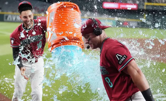 Arizona Diamondbacks' James McCann (8) gets doused in Gatorade by Diamondbacks' Jordan Lawlar (10) in celebration of McCann's eighth inning home run against the Philadelphia Phillies after a baseball game, Wednesday, Sept. 2, 2026, in Phoenix. (AP Photo/Ross D. Franklin)