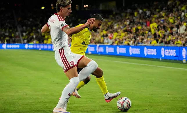 Toronto FC forward Theo Corbeanu, left, battles for the ball with Nashville SC forward Elias Saad, right, during the second half of an MLS soccer match Saturday, Sept. 26, 2026, in Nashville, Tenn. (AP Photo/George Walker IV)