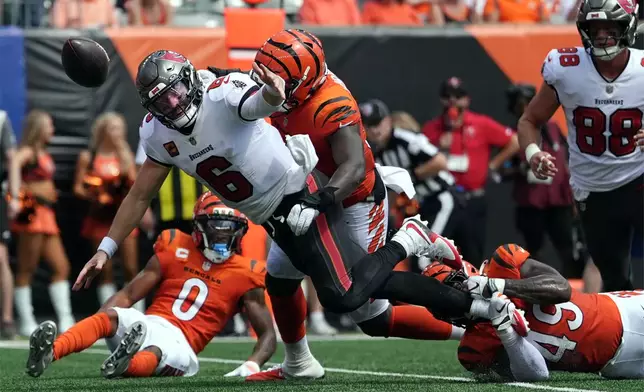 Tampa Bay Buccaneers quarterback Baker Mayfield (6) fumbles as he is hit in the first half of an NFL football game against the Cincinnati Bengals Sunday, Sept. 13, 2026, in Cincinnati. (AP Photo/Joshua A. Bickel)
