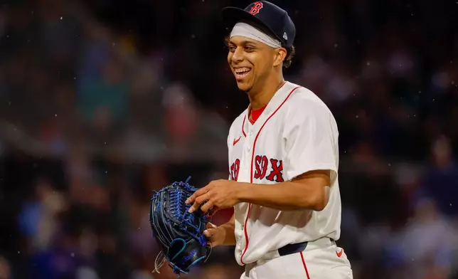 Boston Red Sox pitcher Jedixson Paez smiles after walking off the mound during the seventh inning of the second baseball game of a doubleheader against the Chicago Cubs, Friday, Sept. 25, 2026, in Boston. (AP Photo/Greg M. Cooper)