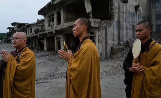 Buddhist monks offer prayers for the departed soul of the victims of flash flood on the bank of Trishuli river in Devighat, Nuwakot district, Nepal, Saturday, Sept. 5, 2026. (AP Photo/Niranjan Shrestha)