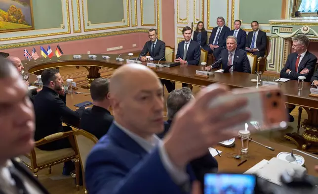 Ukraine's President Volodymyr Zelenskyy, behind left, listens to speeches during a meeting with U.S. envoys Steve Witkoff, sitting second from right, Jared Kushner, sitting second from left, and European representatives in Kyiv, Ukraine, Sunday, Sept. 6, 2026. (AP Photo/Francisco Seco)