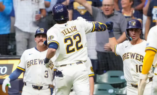 Milwaukee Brewers' Sal Frelick, right, reacts to a three-run home run hit by Milwaukee Brewers designated hitter Christian Yelich (22) during the first inning of a baseball game against the Chicago Cubs Wednesday, Sept. 9, 2026, in Milwaukee. (AP Photo/Kayla Wolf)