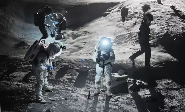 Scientists test newly developed spacesuits at the LUNA analog facility in preparation of future human and robotic missions to the moon, simulating the lunar surface for astronauts and robotic systems for the European Space Agency at the German Aerospace Center near Cologne, Germany, Thursday, Sept. 3, 2026. (AP Photo/Martin Meissner)