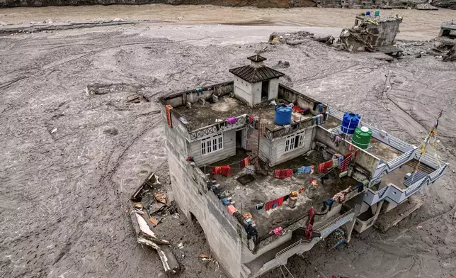 A drone view shows a damaged residential building along the swollen Trishuli River in the aftermath of flash floods in Nepal's Nuwakot district, Thursday, Sept. 3, 2026. (AP Photo/Rajesh Kumar Singh)