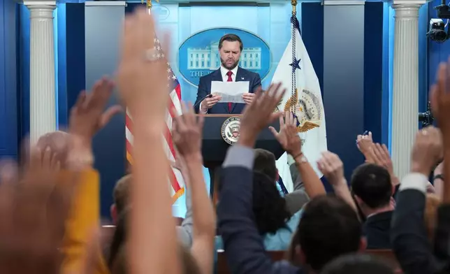 Vice President JD Vance references a media outlet seating chart before selecting a reporter for a question during a press briefing at the White House in Washington, Thursday, Sept. 3, 2026. (AP Photo/Mark Schiefelbein)