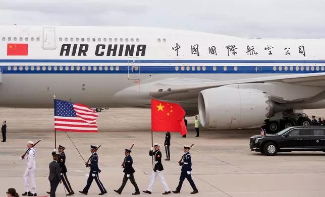 Flags are marched in as an Air China airplane with Chinese President Xi Jinping and his wife Peng Liyuan aboard, arrives at Joint Base Andrews, Md., Wednesday, Sept. 23, 2026. (AP Photo/Mark Schiefelbein)