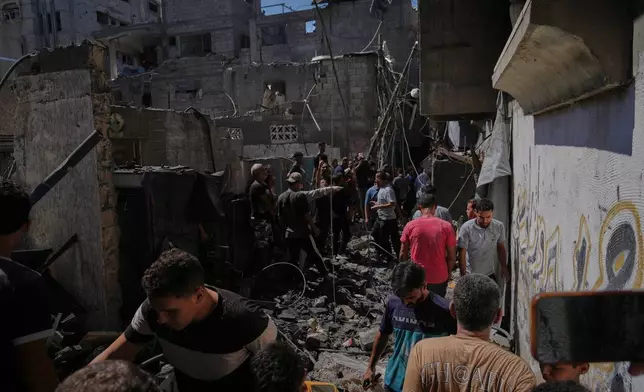 Palestinians inspect a building destroyed in an Israeli airstrike in Gaza City, Wednesday, Sept. 9, 2026. (AP Photo/Jehad Alshrafi)
