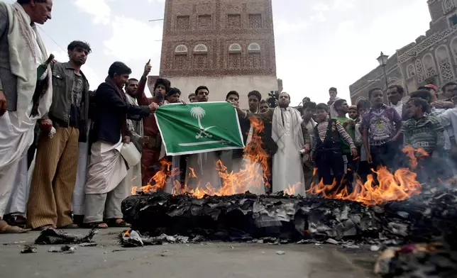 FILE - Members of the Yemeni al-Houthi Shiite rebel group burn an effigy of a U.S. aircraft and a Saudi flag during a demonstration against U.S. and Saudi interference in Yemen, after Friday prayer in Sanaa, Yemen, on April 12, 2013. (AP Photo/Hani Mohammed), File