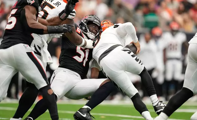 Houston Texans defensive end Will Anderson Jr. (51) sacks Cincinnati Bengals quarterback Joe Burrow (9), right, during the first half of an NFL football game in Houston, Sunday, Sept. 20, 2026. (AP Photo/Ashley Landis)