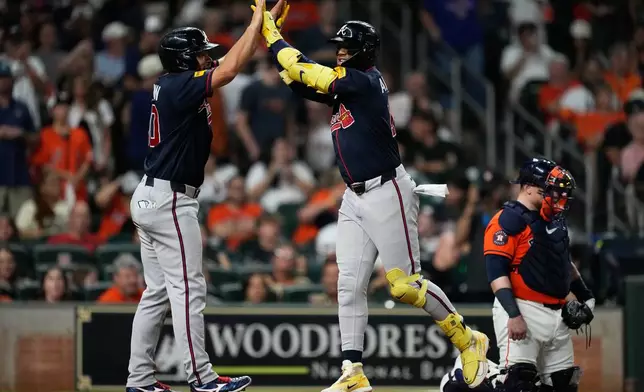 Atlanta Braves' Ronald Acuña Jr., right, celebrates with designated hitter Drake Baldwin after hitting a home run during the seventh inning of a baseball game against the Houston Astros in Houston, Friday, Sept. 18, 2026. (AP Photo/Ashley Landis)