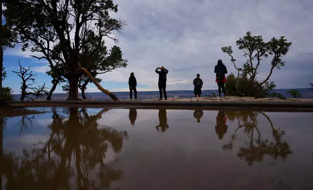 FILE - People stand at the rim of the Grand Canyon, Monday, Aug. 31, 2026, in Grand Canyon National Park, Ariz. (AP Photo/John Locher, File)