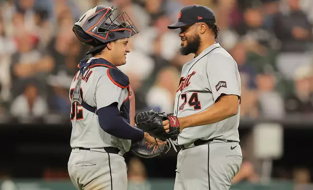 Detroit Tigers' Eduardo Valencia, left, celebrates with Kenley Jansen, right, after a baseball game against the Chicago White Sox, Friday, Sept. 18, 2026, in Chicago. (AP Photo/Melissa Tamez)