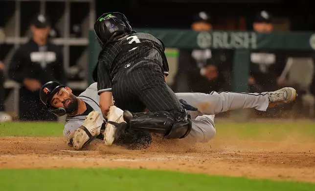 Chicago White Sox's Kyle Teel tags out Detroit Tigers' Riley Greene sliding into home plate on a throw from Braden Montgomery during the seventh inning of a baseball game, Friday, Sept. 18, 2026, in Chicago. (AP Photo/Melissa Tamez)