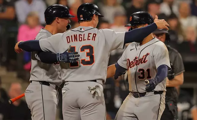 Detroit Tigers' Riley Greene (31) celebrates with Dillon Dingler (13) and Spencer Torkelson, left, after hitting a two-run home run during the eighth inning of a baseball game against the Chicago White Sox, Friday, Sept. 18, 2026, in Chicago. (AP Photo/Melissa Tamez)