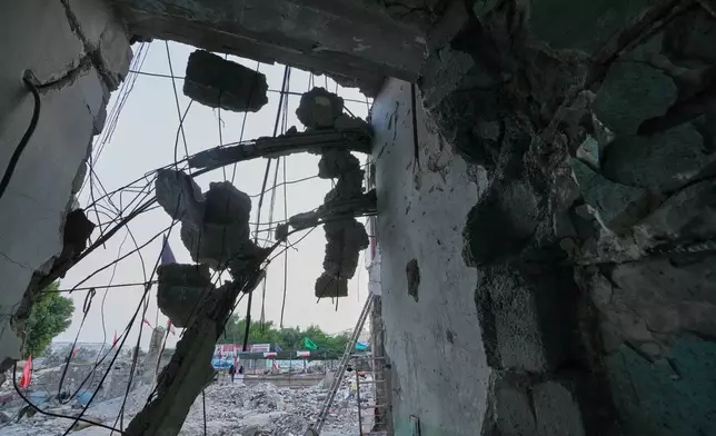Chunks of concrete hang from exposed reinforcing bars at the Shajareh Tayyebeh school, damaged in a Feb. 28 U.S. airstrike in Minab, southern Iran, Monday, Sept. 7, 2026. (AP Photo/Vahid Salemi)