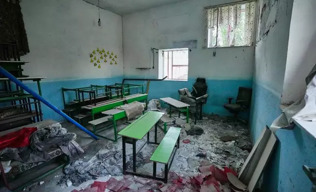 Classroom desks and chairs sit amid rubble at the Shajareh Tayyebeh school, damaged in a Feb. 28 U.S. airstrike in Minab, southern Iran, Monday, Sept. 7, 2026. (AP Photo/Vahid Salemi)