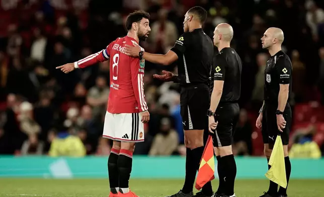 Manchester United's Bruno Fernandes, left, argues with Referee Farai Hallam at the end of the English League Cup third round soccer match between Manchester United and Brighton and Hove Albion in Manchester, England, Wednesday, Sept. 16, 2026. (AP Photo/Dave Thompson)