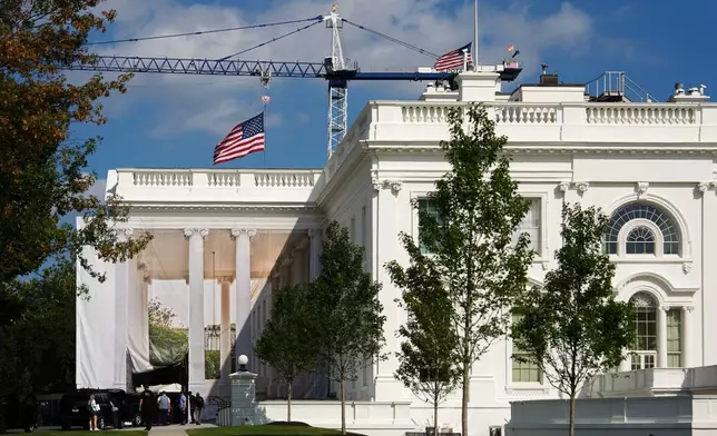 American flags fly at half staff in honor of Dolly Parton, Sunday, Aug. 30, 2026, at the White House in Washington. (AP Photo/Julia Demaree Nikhinson)