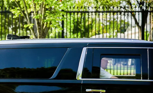 President Donald Trump sits in the back seat of the presidential SUV as he departs the White House en route to Trump National Golf Club, Saturday, Aug. 29, 2026, in Sterling, Va. (AP Photo/Julia Demaree Nikhinson)