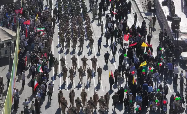 Members of Iran's Revolutionary Guard march through Revolution Square during the state-organized "Janfada," or "Sacrifice for Iran," military-style parade in Tehran, Iran, Friday, Sept. 18, 2026. (AP Photo/Vahid Salemi)