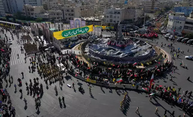 Members of Iran's Revolutionary Guard and other participants march through Revolution Square during the state-organized "Janfada," or "Sacrifice for Iran," military-style parade in Tehran, Iran, Friday, Sept. 18, 2026. (AP Photo/Vahid Salemi)